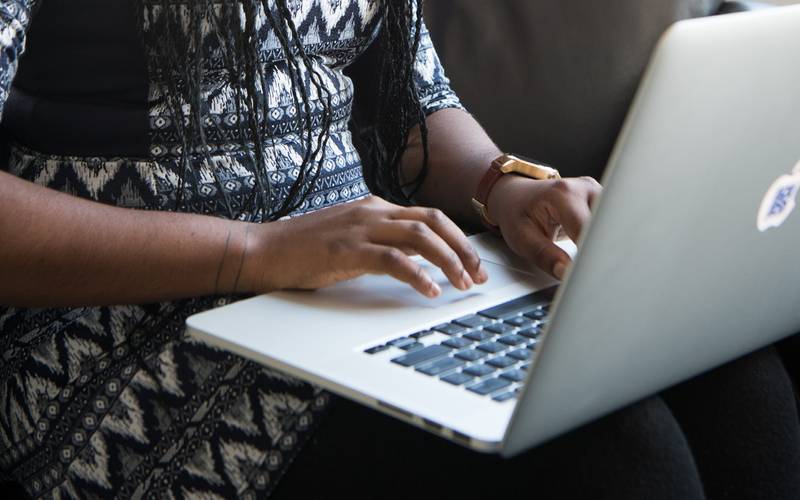 Canva Woman Sitting Holding Silver Macbook