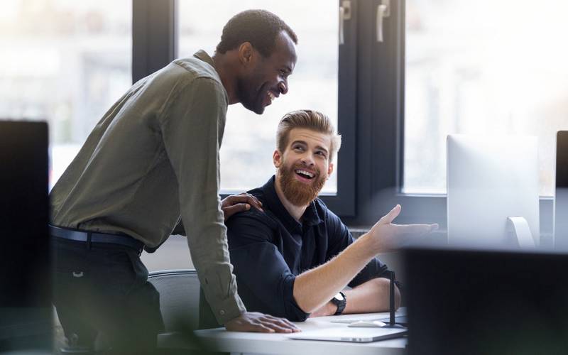 two happy men working together new business project