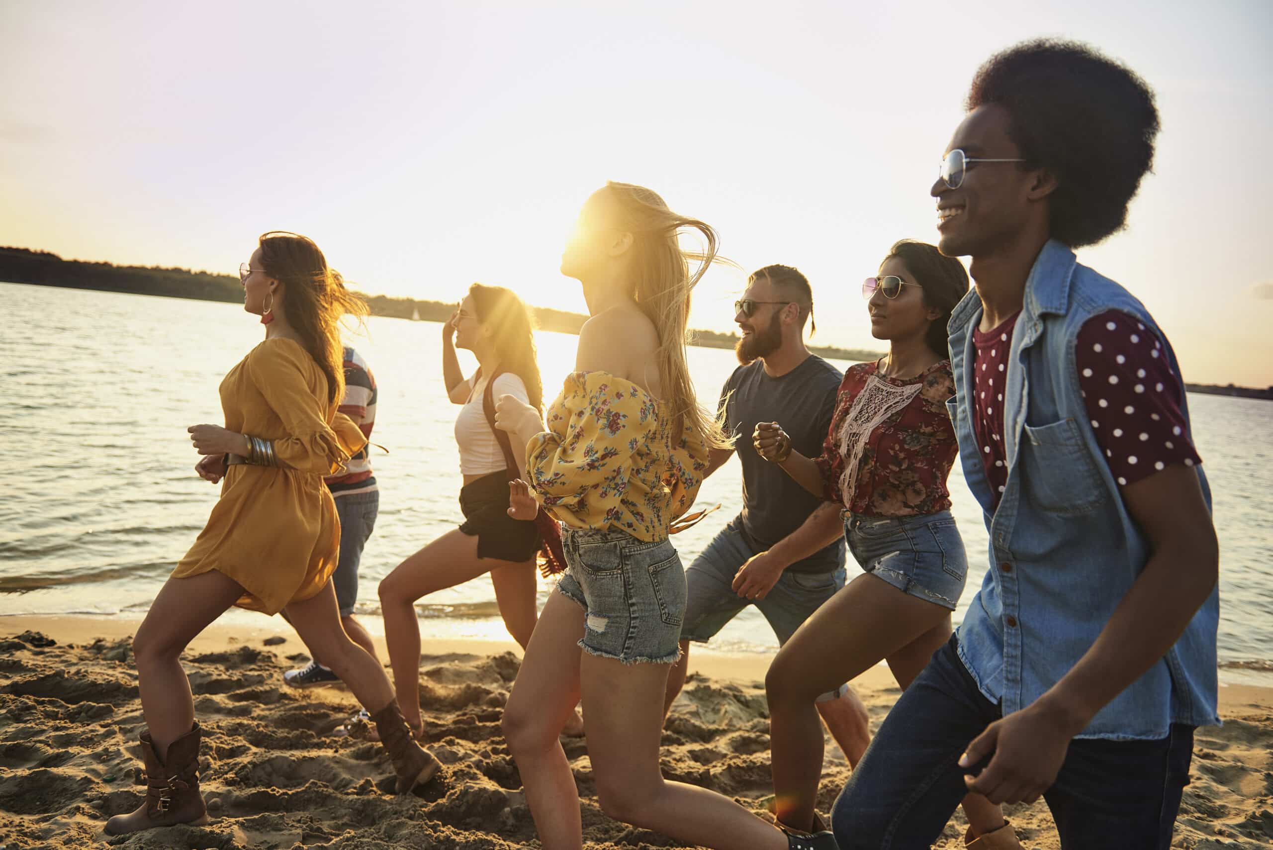 group fiends running beach sunset scaled